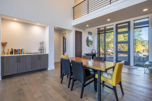 a kitchen and dining room with a wooden table and chairs at Suncadia 7 Bdrm Home with Amazing View and a Hot Tub in Cle Elum