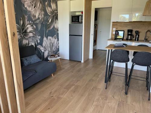 a living room with a couch and a table at Lovely beach in Sainte-Maxime
