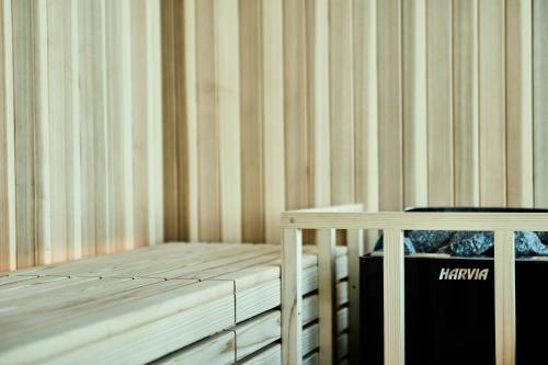 a small bed in a striped room with a table at Snow Peak YAKEI SUITE ABURAYAMA FUKUOKA in Fukuoka