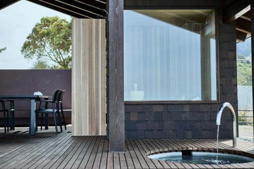 a patio with a sink and a table on a deck at Snow Peak YAKEI SUITE ABURAYAMA FUKUOKA in Fukuoka
