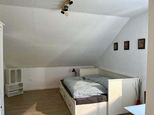 een slaapkamer met een bed in een witte kamer bij Natur pur im schönen Sauerland in Allendorf