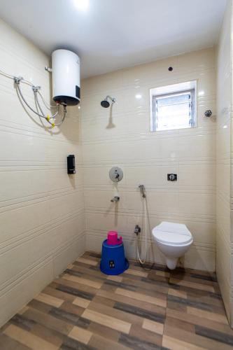 a bathroom with a toilet and a shower at Hotel Park Central in Kolkata