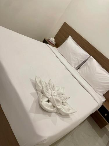 a white flower sitting on top of a bed at برج ماجيك سويت Magic Suite Tower in Kuwait