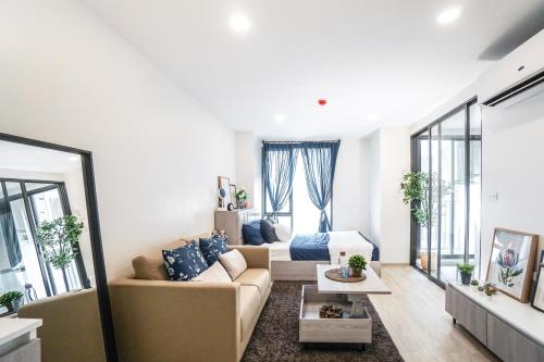 a living room with a couch and a table at I'm Chinatown Residence in Bangkok