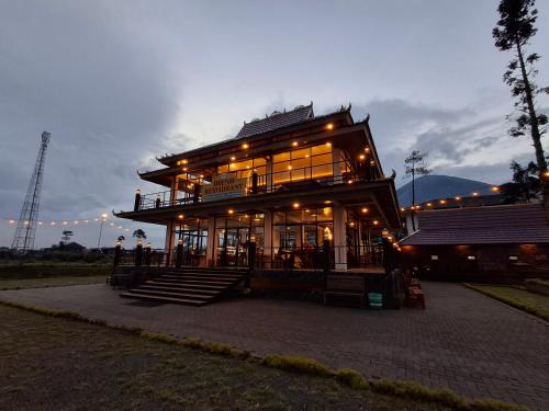 a large building with a lot of windows at Dieng Kledung Pass Hotel & Restaurant in Wonosobo