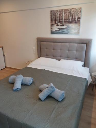 a bed with two pillows on top of it at AniBo studios & apartments center 3861 in Thessaloniki