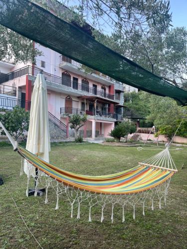 a hammock in a park next to a building at Exohi apartments in Vrasná