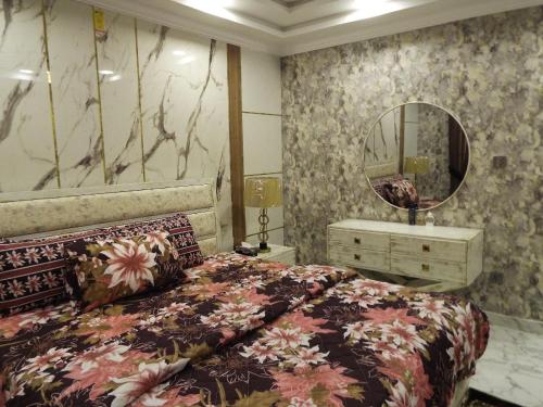 um quarto com uma cama grande e um espelho em Luxurious 2 Bedroom Penthouse For Rent em Rawalpindi