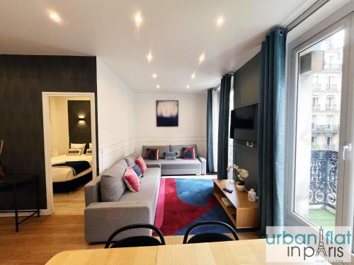 un salon avec un canapé et un lit dans l'établissement Urban Flat 24 - Charming Home in Paris, à Paris