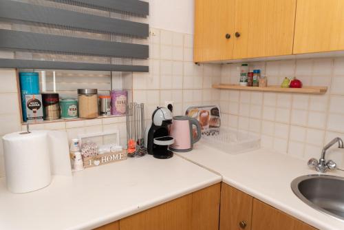 a kitchen counter top with a sink and a counter top at Bluehouse in Porto Rafti