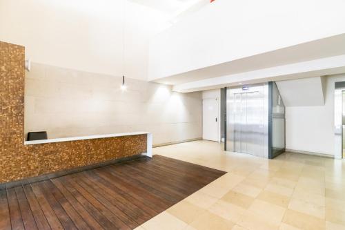 an empty room with a stone wall and a lobby at Unique Rentals - Placa Catalunya Central Apartments in Barcelona