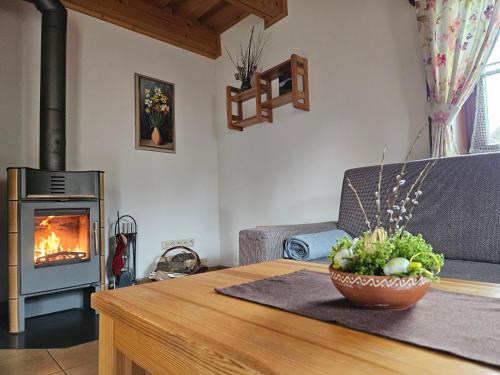 a living room with a table with a fireplace at Drevenice Zuberec in Zuberec