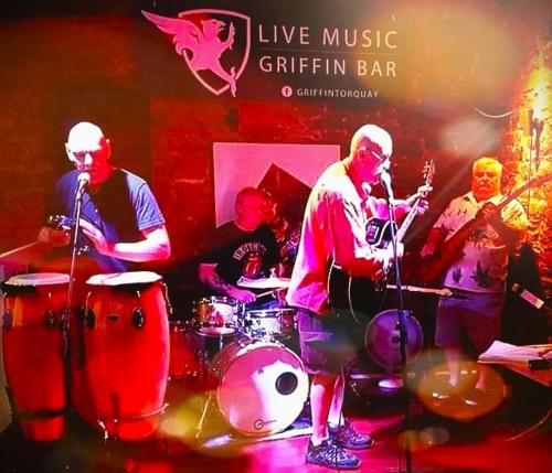 a group of people playing drums on a stage at Yardley Manor Hotel in Torquay