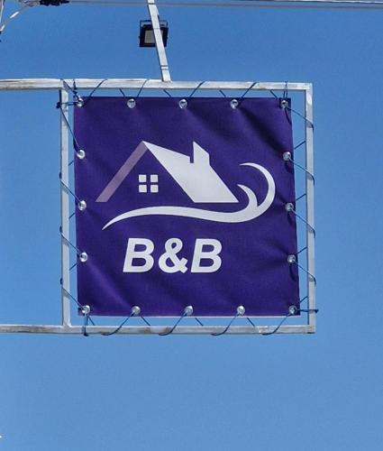 a sign for a house with a bbc on it at Guest House David's B&B in Gyumri