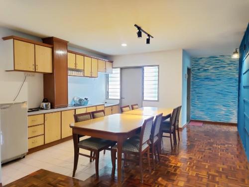 a kitchen with a table and chairs and a refrigerator at The Little Star Hotel & Studio at Star Regency Residence in Brinchang