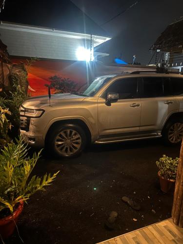 a white suv parked in a driveway at night at Safari villa in Arusha