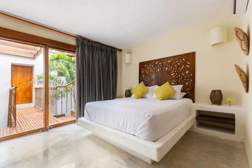 a bedroom with a bed and a large window at Casa Coco 1680 Colonial & Art House In Old City - Pool - Jasussi - View in Cartagena de Indias