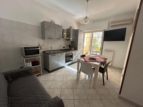a kitchen with a table and a kitchen with a stove and a tableablish at Casa Sophie in Oristano