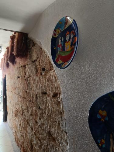 two plates are hanging on a wall at da Cappellini in Isola delle Femmine
