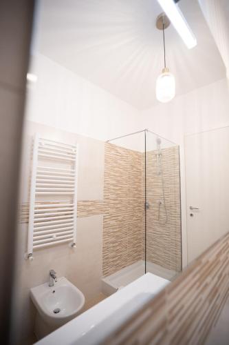 a bathroom with a shower and a toilet and a sink at AirPort NOA Modern Home in Fiumicino
