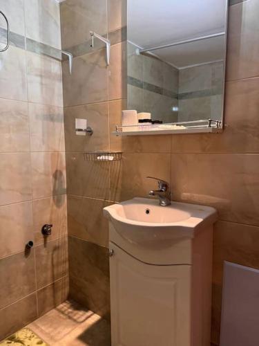 a bathroom with a sink and a mirror at Family Woodland Oasis VIPGreece in Kírinthos