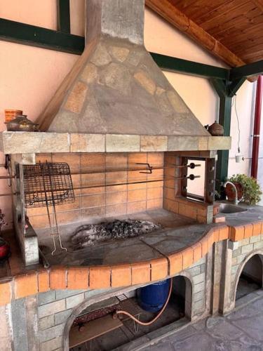 a brick oven with a stove top in a building at Family Woodland Oasis VIPGreece in Kírinthos