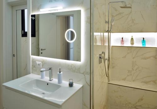 a bathroom with a sink and a shower at House of the Twins in Mesagne