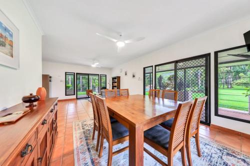 a dining room with a wooden table and chairs at Riverside Homestead in Southport