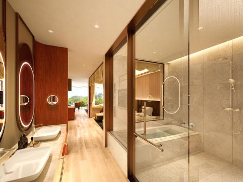 a bathroom with two sinks and a shower at Hotel Springs Makuhari Premier in Chiba