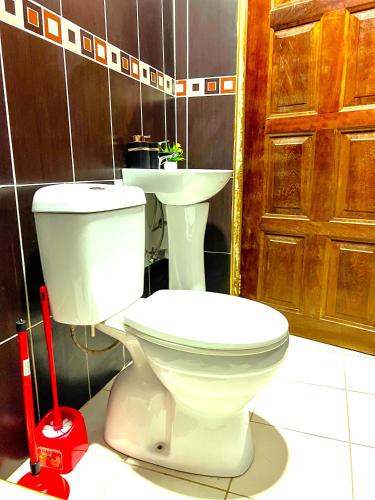 a bathroom with a toilet and a sink at Maryluxe Stays in Accra