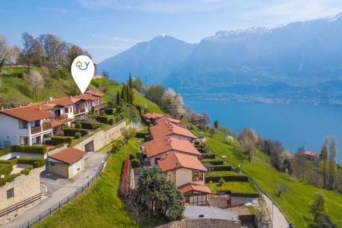 an aerial view of a village with a lake and mountains at Balcone sul Lago - Happy Rentals in Tremosine Sul Garda