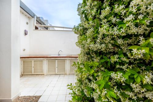 a wall of flowers in the courtyard of a house at Villa Buganvillea near the beach in Maracalagonis