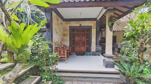 a front door of a house with plants at Pala House in Ubud