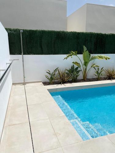 a swimming pool in the middle of a house at Inmovecos villa de lujo Cabo Negrete in Cabo de Palos