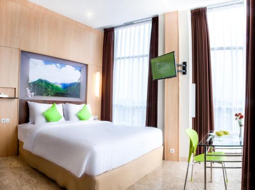 Tebu Hotel Bandung tesisinde bir odada yatak veya yataklar
