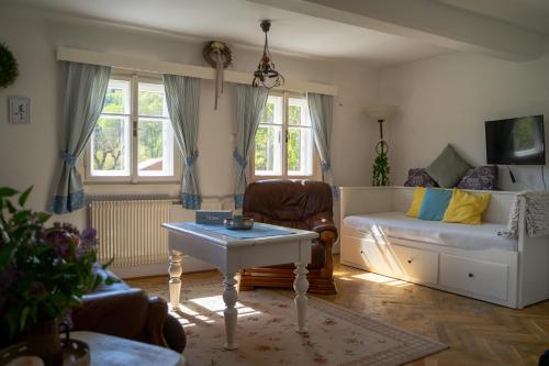 a living room with a couch and a table at Roubenka Doubravice in Hrubá Skála