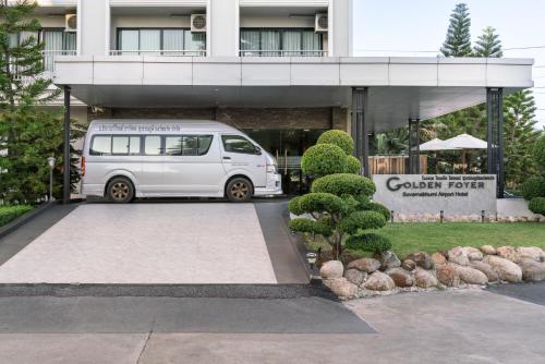 a white van parked in front of a building at Golden Foyer Suvarnabhumi Airport Hotel in Lat Krabang