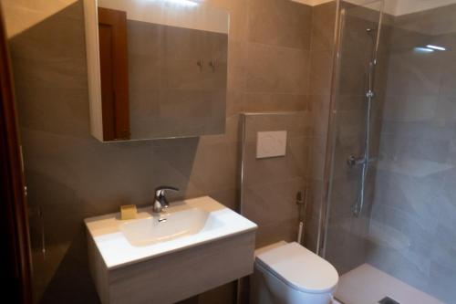 a bathroom with a sink and a shower and a toilet at Ermete Eur House in Rome