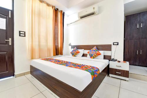 a bedroom with a large bed in a room at FabHotel KRB Paradise in Dehradun