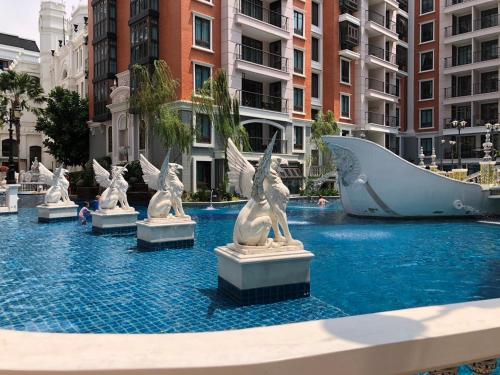 a group of statues in the water in a city at Espana Condo Resort By K&T in Jomtien Beach