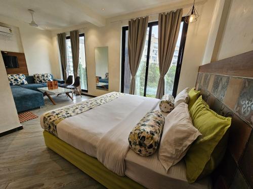 a bedroom with a large bed and a living room at Nova Park in Rajkot