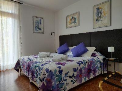 a bedroom with a large bed with blue pillows at Verona Relax & Stay APARTMENTS in Verona