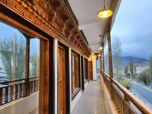 a hallway with windows in a building with a view at Zanu Residency in Leh