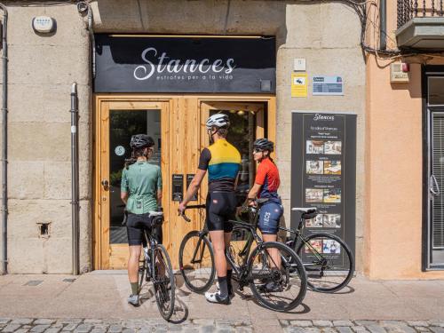 three people on bikes in front of a store at Luxury Apartment Stancesvic LOFT (New) in Vic