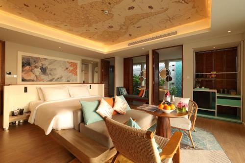 a bedroom with a bed and a table and chairs at TTC Van Phong Bay Resort - Himalaya Sauna & Steam Retreat Included in Ninh Hòa