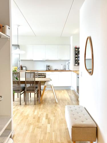 a kitchen and dining room with a table and chairs at Modern Apartment with Amazing Views in Copenhagen