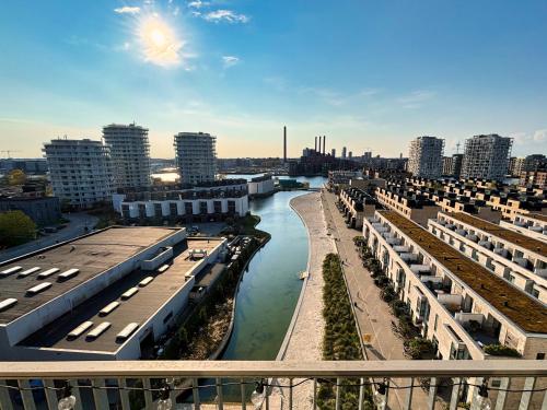 a view of a river in a city with buildings at Modern Apartment with Amazing Views in Copenhagen
