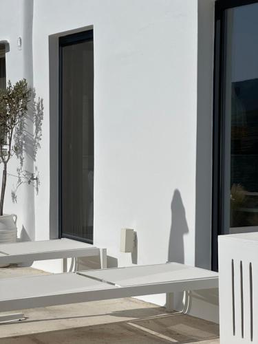 a white room with two benches and a window at AESIS in Krokos