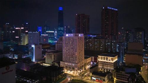 a view of a city at night with at Hotel Royal Signature in Kuala Lumpur