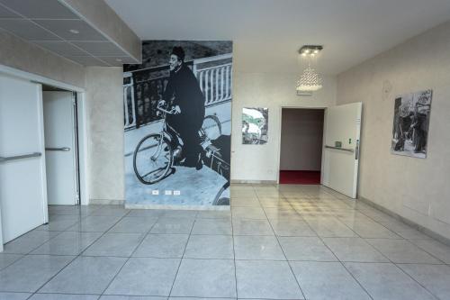 a hallway with a mural of a man on a bike at HOTEL DON CAMILLO in Brescello